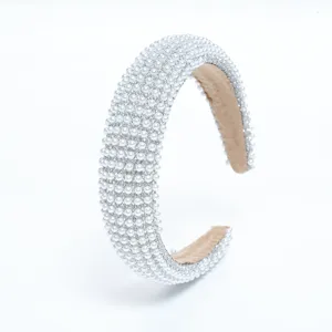 Close up of pearl and rhinestone headband, sparkling crystal hair hoop detail view.