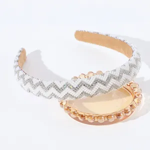 Vista dettagliata cerchietto per capelli con perle e strass, accessorio brillante.