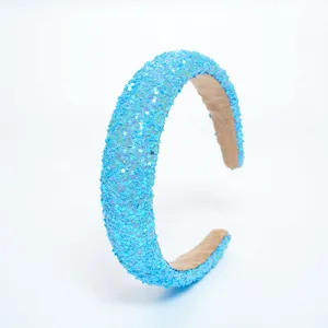 Blue glitter star headband detail shot, sparkling sequin hair hoop close up view.