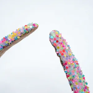 Detailed close-up shot of sparkling colorful star headband, sweet fairy hair accessory for women.