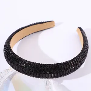 Detail view of black rhinestone padded headband sparkling crystal hair accessory for women.