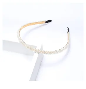 Close-up detail view of the elegant pearl braided headband, showing fine pearl embellishments.