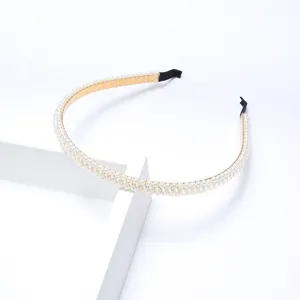 Elegant pearl headband with gold metal base, minimalist design for daily wear and party styling.
