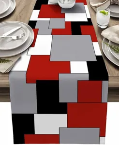 Moderno camino de mesa geometrico en rojo, negro, gris y blanco. Detalle de decoracion.