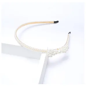 Pearl headband detail shot, elegant bridal hair accessory with delicate white pearls.