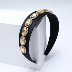 Cerchietto barocco vintage in strass con pietre d'ambra scintillanti e tesa larga.