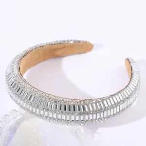 Close-up detail of luxurious rhinestone padded headband sparkling crystal hair accessory.