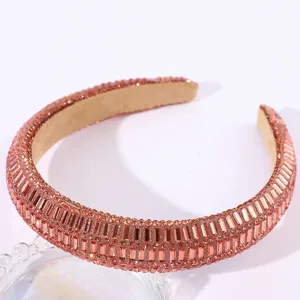 Close-up detail of the luxury sparkling rhinestone padded headband, shiny crystal hair accessory.
