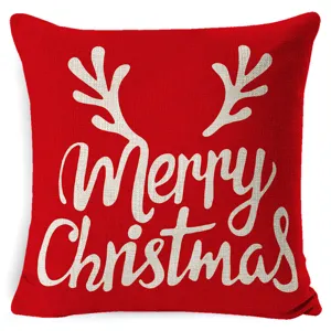 Housse de coussin rouge de Noel avec des bois de renne blancs et une typographie festive.