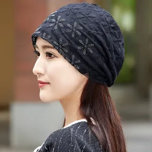 Close-up detail of the black lace chemo cap with sparkling rhinestone floral pattern for women.