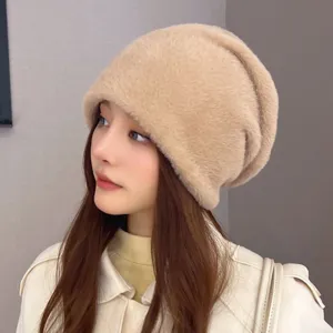 Close-up detail of the soft fluffy warm winter knit beanie hat, showing cozy texture and wear.