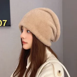 Close-up detail shot of a fluffy warm winter knit beanie hat in stylish beige color, cozy.