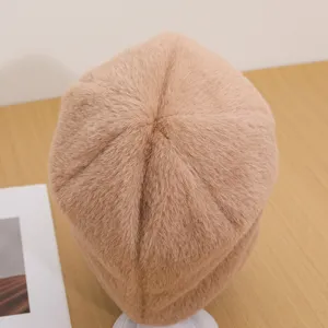Close-up detail of cozy plush faux fur winter beanie hat in khaki, warm and soft texture.