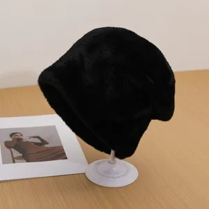 Detail shot of the plush black winter warm hat on display stand, cozy and soft texture.
