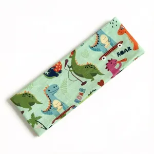 Primo piano dettagliato della fascia elastica verde per bambini con simpatici dinosauri stampati.