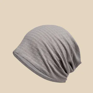 Detail view of breathable grey slouchy chemo hat, lightweight knit fabric for women comfort.