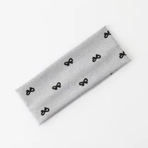 Fascia per capelli grigia con fiocco da donna, fascia sportiva assorbente e accessorio quotidiano.