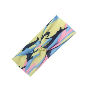 Dettaglio fascia per capelli larga con stampa mimetica colorata, accessorio yoga.