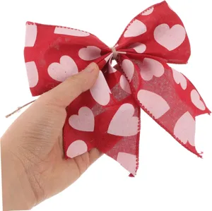 Nahaufnahme der roten Juteschleife mit rosa Herzen, perfekt für Valentinstag Bastelarbeiten.