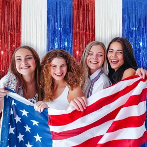 Detailed scene of shimmering red white and blue tinsel curtain backdrop for festive party decor.