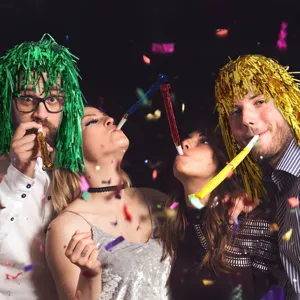 Shiny metallic tinsel foil party wig and colorful festival headwear for celebration.