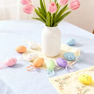 Detailed shot of colorful speckled Easter egg ornaments with ribbons, perfect for holiday home decor.