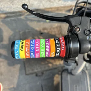 Close-up detail of colorful silicone handlebar grips installed on bicycle or e-bike scooter.