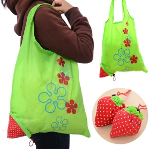 Foldable eco-friendly shopping bag with cute strawberry pouch design, durable polyester.