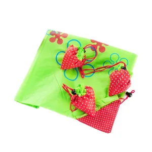 Folding strawberry shopping bag with storage pouch, eco-friendly polyester reusable grocery tote.