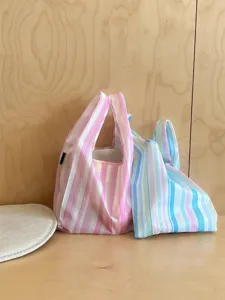 Detailed view of colorful striped folding shopping bags, showing portable design and texture.