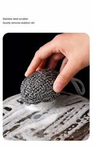 Stainless steel wire mesh cleaning ball detail showing foam washing scene in kitchen use.