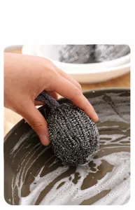 Stainless steel cleaning ball with lanyard, durable kitchen scrubber for pots and pans.