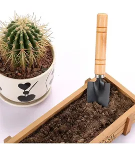 Mini garden shovel with wooden handle for indoor potted plants and soil loosening work.