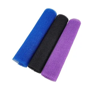 Close-up of colorful mesh bath scrubber rolls showing textured nylon fabric weave details.