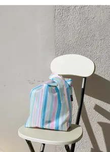 Close-up detail of the striped mini folding shopping bag, portable waterproof handbag design.