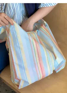 Colorful striped waterproof folding shopping bag detail, portable reusable tote for grocery.