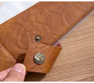 Close-up detail of premium leather binder organizer showing fine texture and metallic snap button.