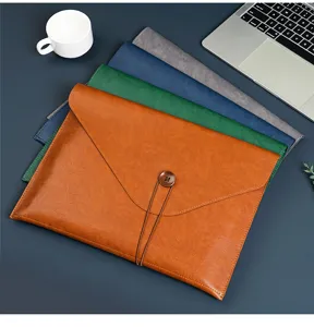 Close up detail of premium faux leather document folder showing button closure and texture.