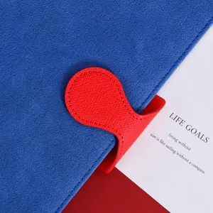 Blue leather notebook with red magnetic buckle, stylish minimalist journal for office and school.
