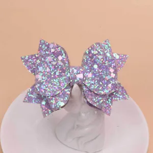 Detailed shot of a purple glitter bow hair clip, stylish accessory with double layer design.