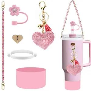 Pink Stanley tumbler accessory set with daisy straw cover, chain strap and rhinestone keychain