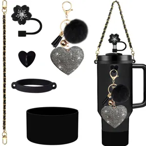 Detail shot of rhinestone heart keychain, gold chain strap, and black straw topper for cups.