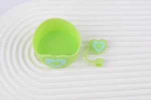 Light green silicone cup sleeve and heart straw cap detail, practical kitchen accessory.