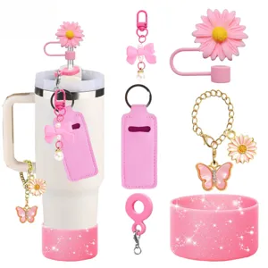 Pink tumbler accessory set with silicone straw cover, bow flower charms, and cup boot for 40oz.