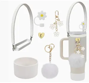 Tumbler accessory set with silicone strap, daisy straw cover, plush pom-pom and floral charms.
