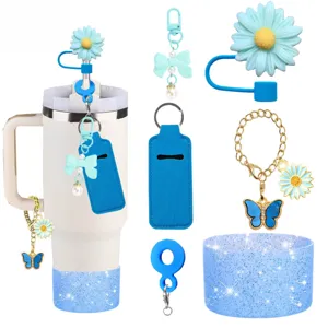 Details of blue silicone tumbler straw topper bow charm cup chain and silicone boot accessories.