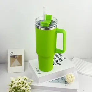 Green 40oz insulated stainless steel tumbler with handle and straw, close up detail.