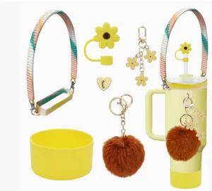 Tumbler accessory set with colorful woven strap, floral straw cover, and fluffy pom-pom charm.