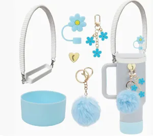 Detailed view of tumbler accessory set, silicone boot, strap, and cute flower plush charms.