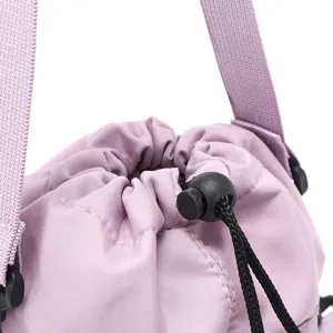 Close-up detail of a light purple drawstring water bottle bag with black cord and strap.